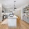 Spacious and well lit kitchen with wood flooring and stainless steel appliances