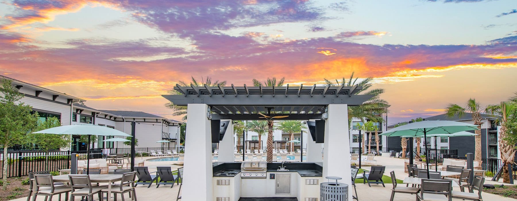 Large sparkling blue pool with lounge chairs and cabanans