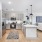 Spacious and well lit kitchen with wood flooring and stainless steel appliances