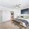 Large well lit bedroom with plush carpets and large windows 