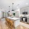 Spacious and well lit kitchen with wood flooring and stainless steel appliances